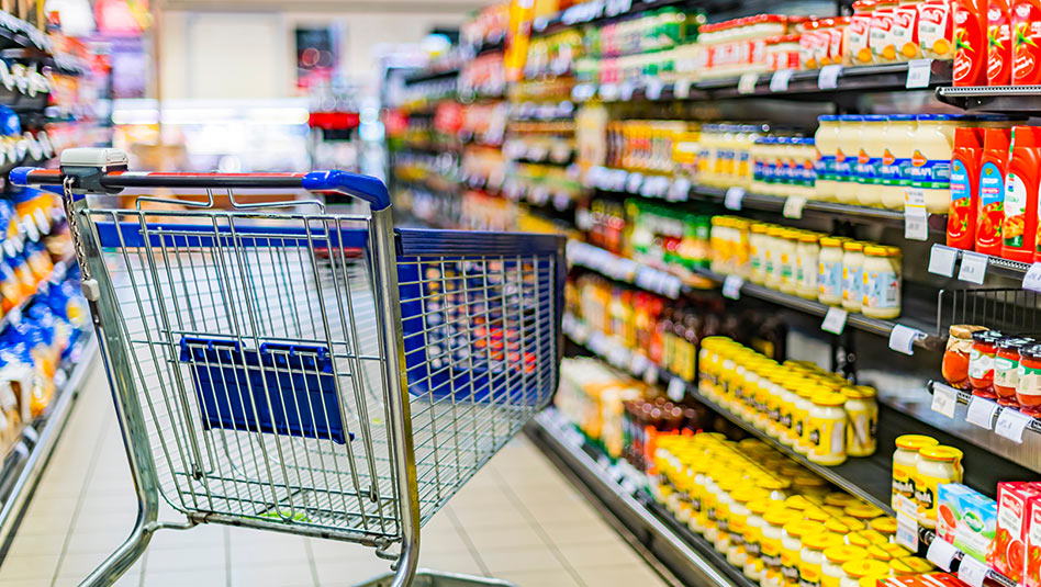 empty grocery cart in the middle of the aisle