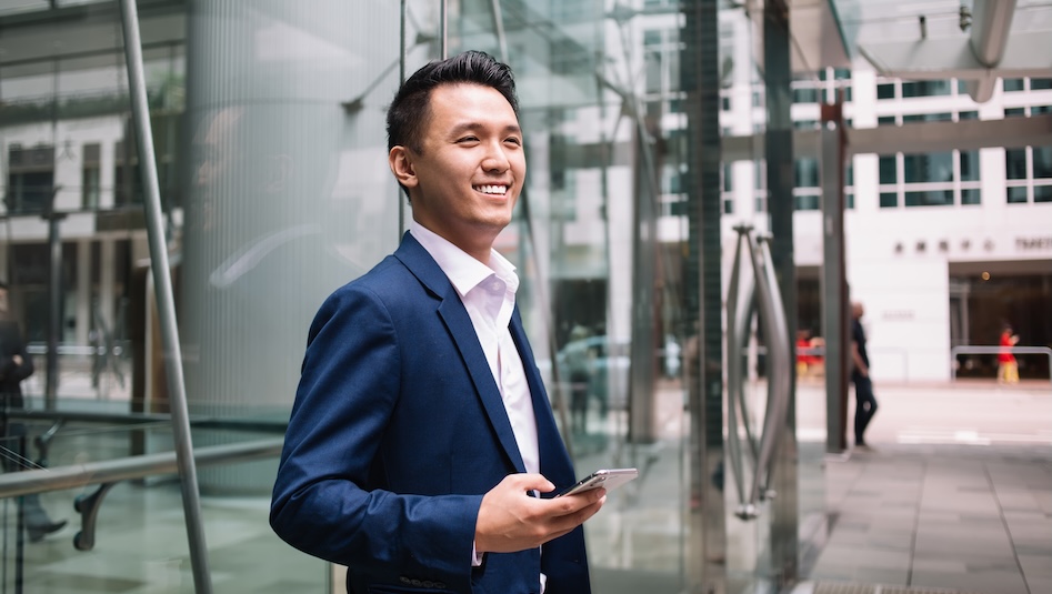 Asian businessman looking away and smiling